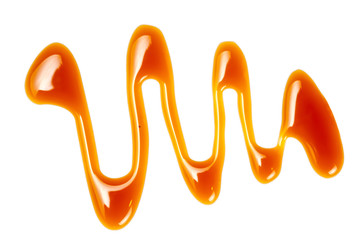 Sweet Caramel sauce isolated on white background close up. Flowing caramel