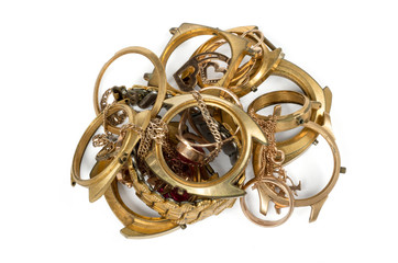 A scrap of gold. Old and broken jewelry, watches of gold an isolated on a white background..