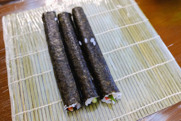 Sushi roll making, close up on table