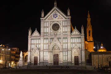 Fototapeta na wymiar View of the Basilica di Santa Croce by night in Florence. There is the tomb of Gallileo in the church.