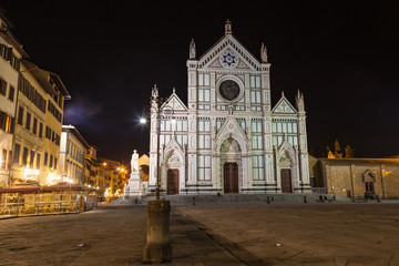 Fototapeta na wymiar View of the Basilica di Santa Croce by night in Florence. There is the tomb of Gallileo in the church.