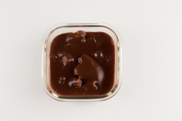 Chocolate pudding with rusk in a glass bowl