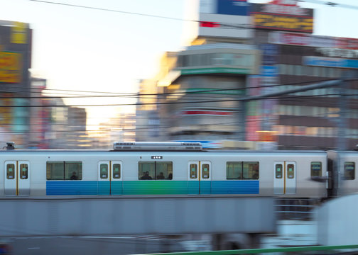 Tokyo,Japan-March 17, 2018: Panning of commuter train running near Takadanobaba station early in the Saturday morning.