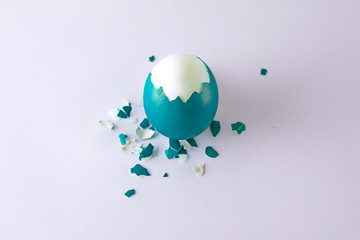 half peeled blue Easter egg