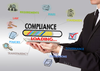 compliance concept, young man holding a tablet computer.