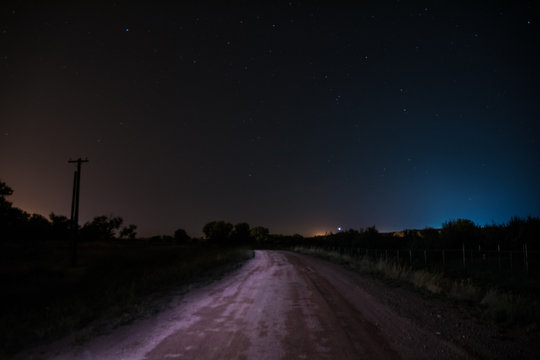 Starry road with blue and red lights in the night sky