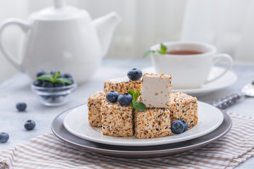 Homemade sweets or candies Pigeon's milk with a cup of tea, blueberries and mint