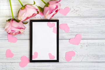 Empty dark frame decorated with pink hearts and pink flowers