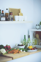 Young woman standing near desk in the kitchen