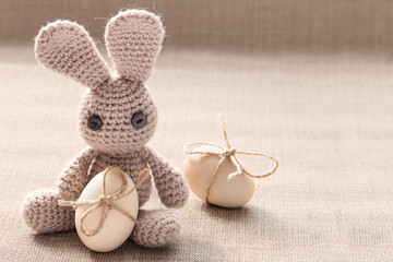 Easter knitted bunny toy with easter eggs. .Easter egg with ribbon bow. Vintage style easter  card.