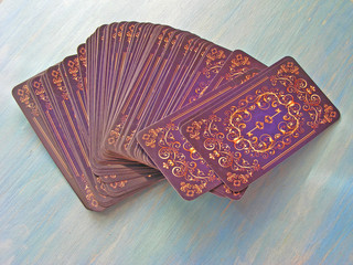 Tarot cards medieval symbol back design isolated on blue wooden background, Tarot Decks