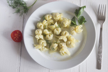 a plate of cooked small dumplings