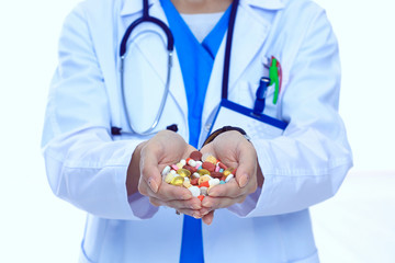 Doctor holding heap of drugs in a hand