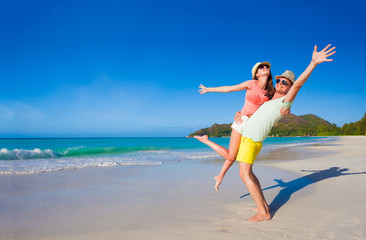 young family in love having fun at tropical Cote d Or beach. Praslin, Seychelles