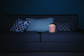 Comfortable couch with popcorn indoors. Home cinema