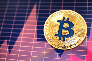 Golden bitcoin on screen with chart. Finance trading
