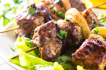 Grilled shish kebab or shashlik on white.