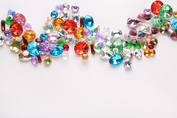 Composition of colorful precious stones for jewellery on white background