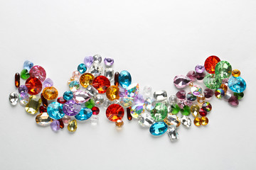 Composition of colorful precious stones for jewellery on white background