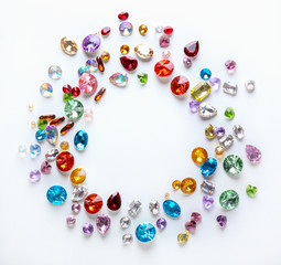 Frame made of colorful precious stones for jewellery on white background