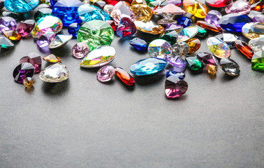 Colorful precious stones for jewellery on grey background