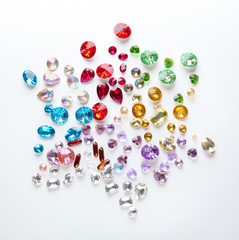 Composition of colorful precious stones for jewellery on white background