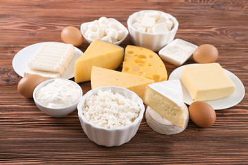 Different dairy products and eggs on wooden table
