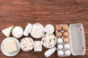 Fototapeta na wymiar Different dairy products and eggs on wooden background