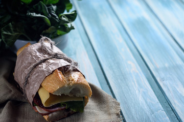 Sandwiches with beef, fresh vegetables and herbs on Provence color wooden background, close  up, horizontal. Selective focus.