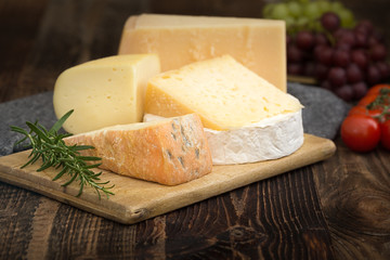 Cheeses with basil, rosemary, tomatoes and grapes.