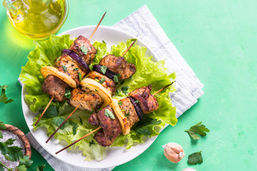 Grilled shish kebab or shashlik on green table.