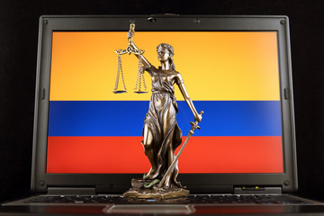 Symbol of law and justice with Colombia Flag on laptop. Studio shot.
