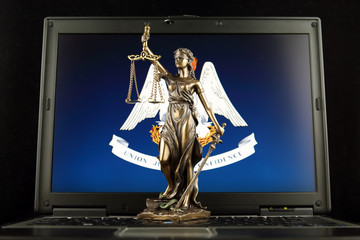 Symbol of law and justice with Louisiana State Flag on laptop. Studio shot.