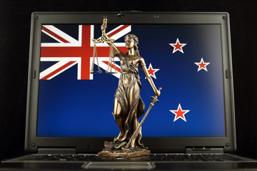 Symbol of law and justice with New Zealand Flag on laptop. Studio shot.