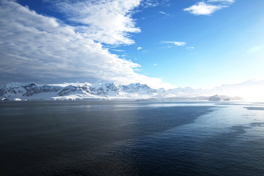 Antarctica on a Sunny day- Antarctic Peninsula - Huge Icebergs and blue sky.