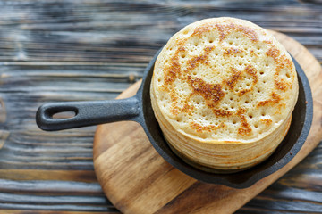 Cast iron pan with stack of fresh pancakes