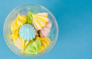 colored meringue on a blue background