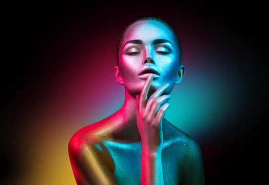 Fashion Model Woman In Colorful Bright Sparkles And Neon Lights Posing In Studio, Portrait Of Beautiful Sexy Girl. Art Design Colorful Vivid Makeup