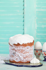 Traditional easter cake with meringue, Kulich, on the wooden table. Selective focus