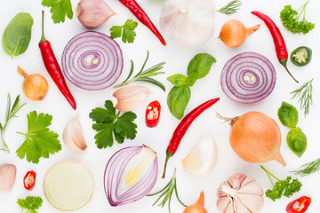 Onion and spices isolated on white background, top view. Wallpaper abstract composition of vegetables.