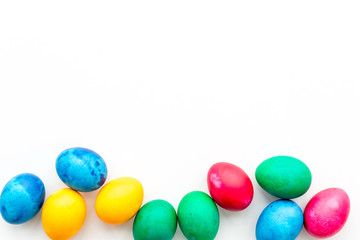 Fototapeta na wymiar Colorful easter eggs on white background top view mockup