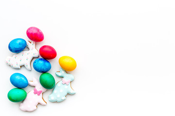 Colorful easter eggs on plate on white background top view mockup