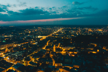panoramic view of old european city on twilight with red sky. bird's eye view.