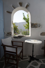 A small table and a chair on a small balcony in Amorgos, it's just what you need after a full day...