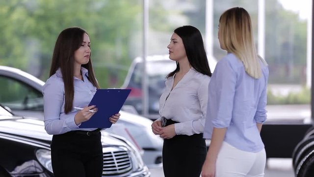 Young Female Manager Talking With Customers