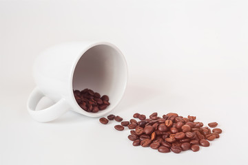 Coffee beans in coffee cup isolated on white