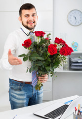 Young man ready to present flowers to woman