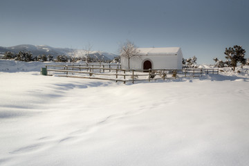 hermitage in natural park of Guadarrama. Snow in mountain of Segovia, Spain