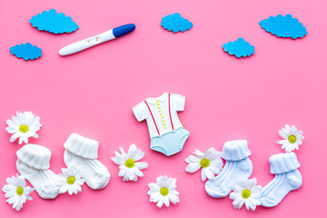 Waiting for a baby with positive pregnancy test and flowers pink background top view mockup