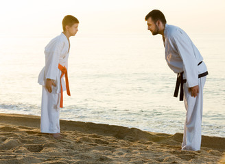 Man and boy exercising karate © JackF